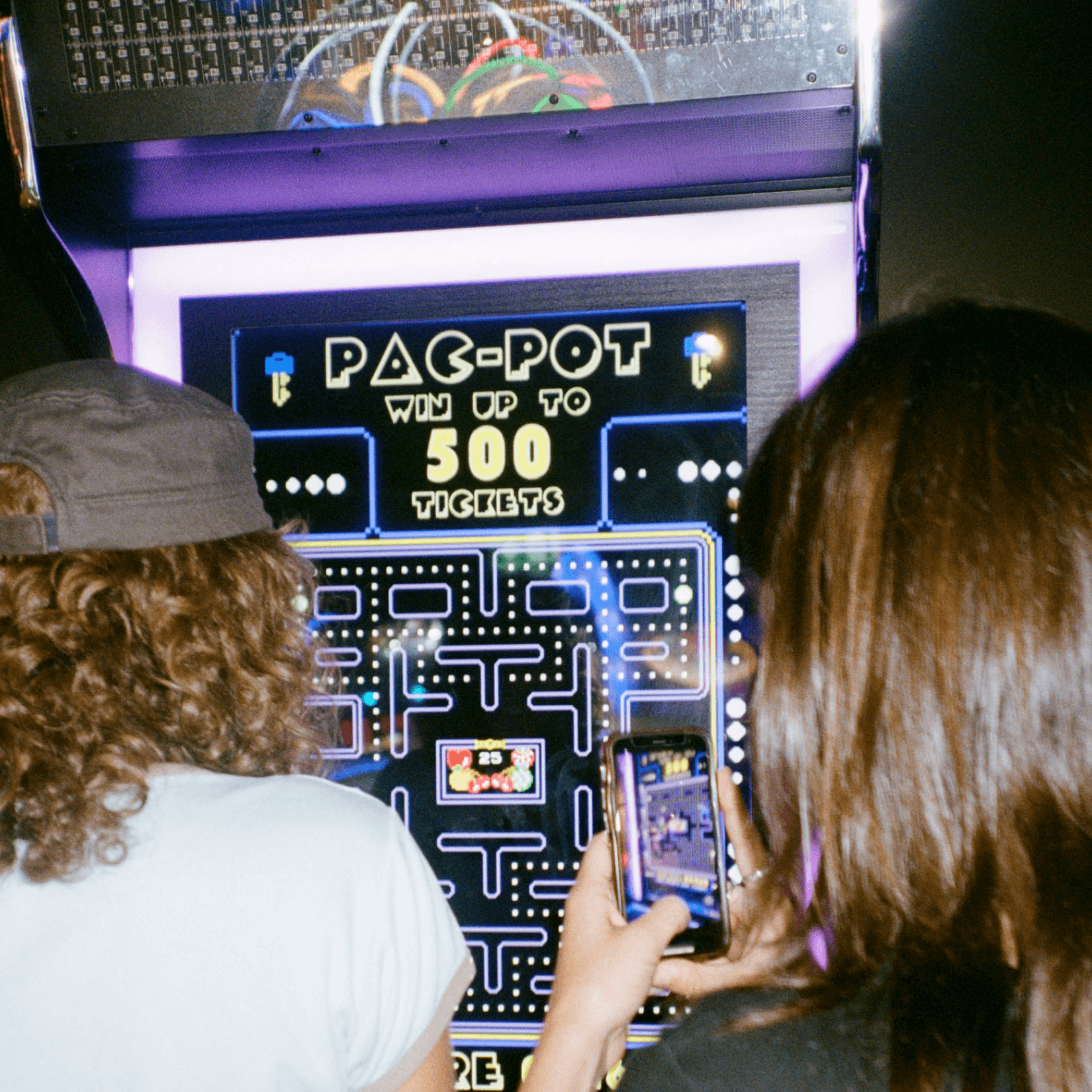Film photo of guests playing Pacman